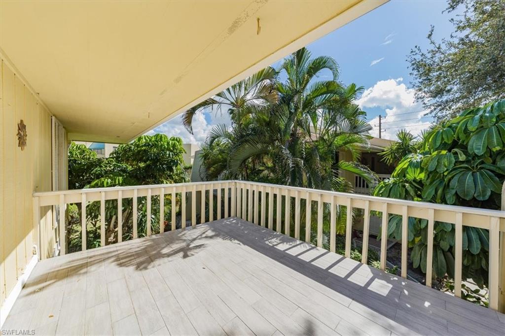 925 Palm View Drive, Unit E118 Naples, FL 34110 - Photo 25 of 26 a view of balcony with wooden floor