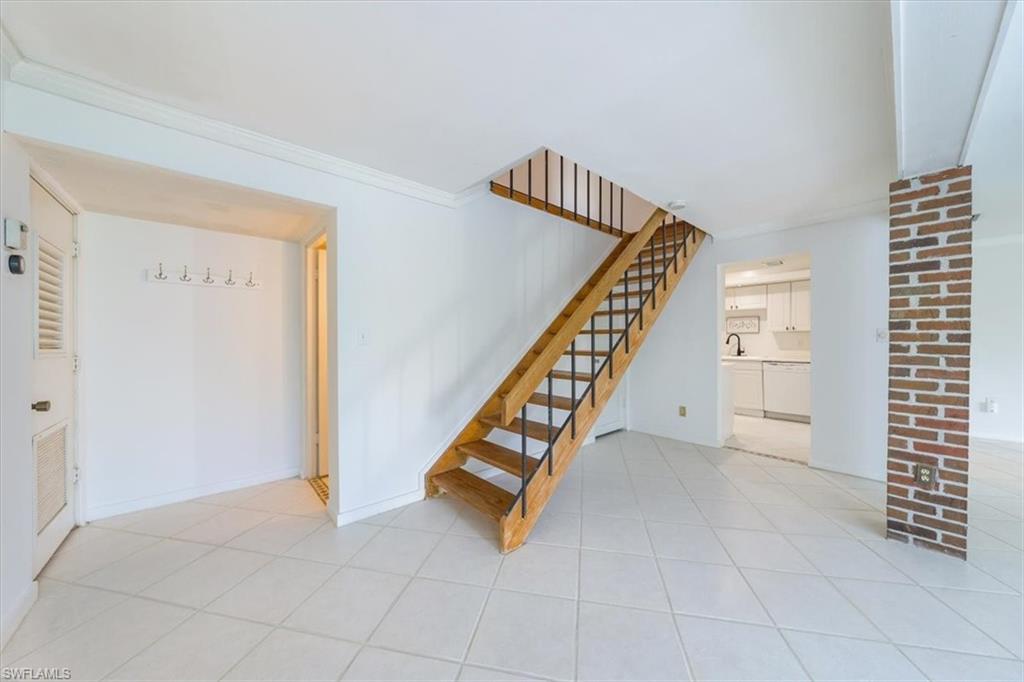 925 Palm View Drive, Unit E118 Naples, FL 34110 - Photo 3 of 26 a view of an entryway with staircase