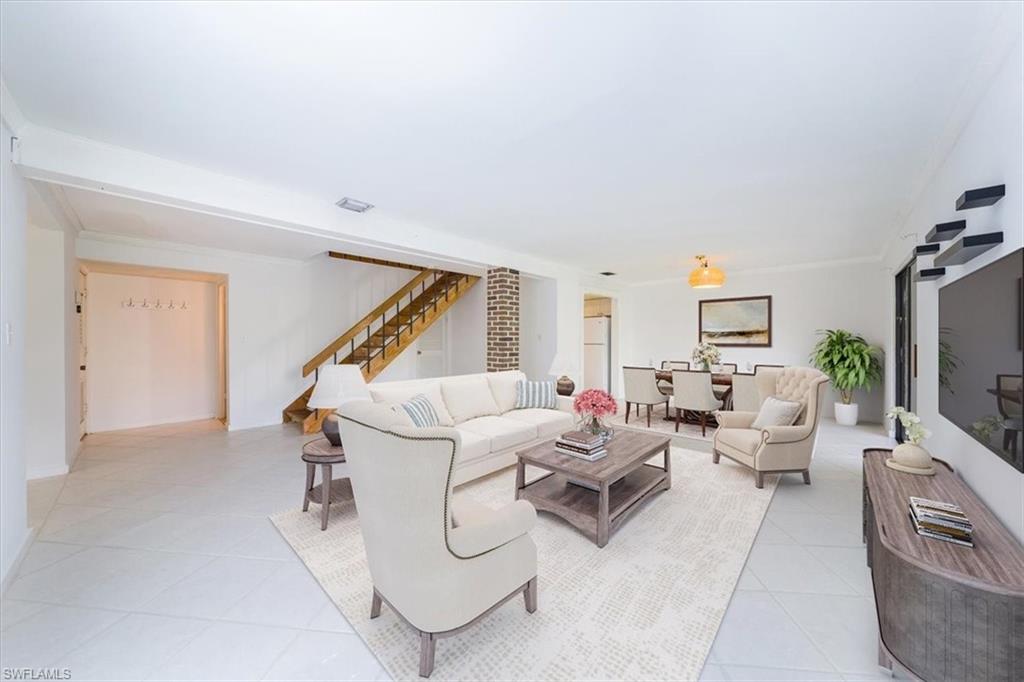 925 Palm View Drive, Unit E118 Naples, FL 34110 - Photo 4 of 26 a living room with furniture and a flat screen tv