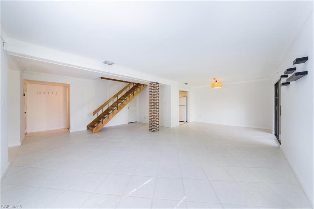 925 Palm View Drive, Unit E118 Naples, FL 34110 - Photo 5 of 26 a view of an empty room with stairs