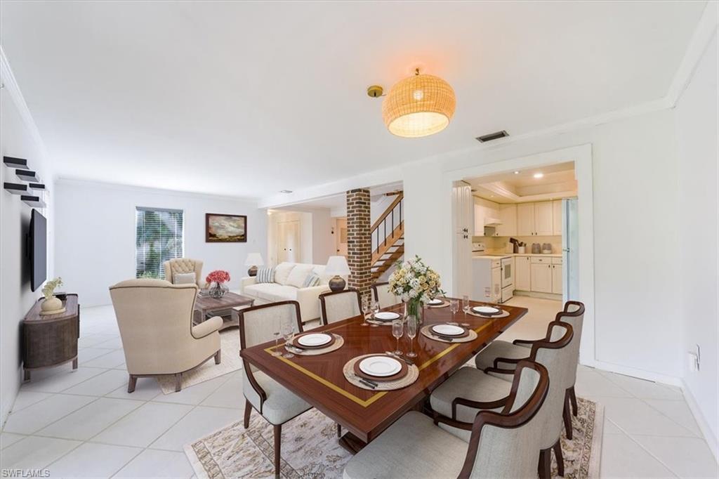 925 Palm View Drive, Unit E118 Naples, FL 34110 - Photo 9 of 26 a living room with furniture and wooden floor