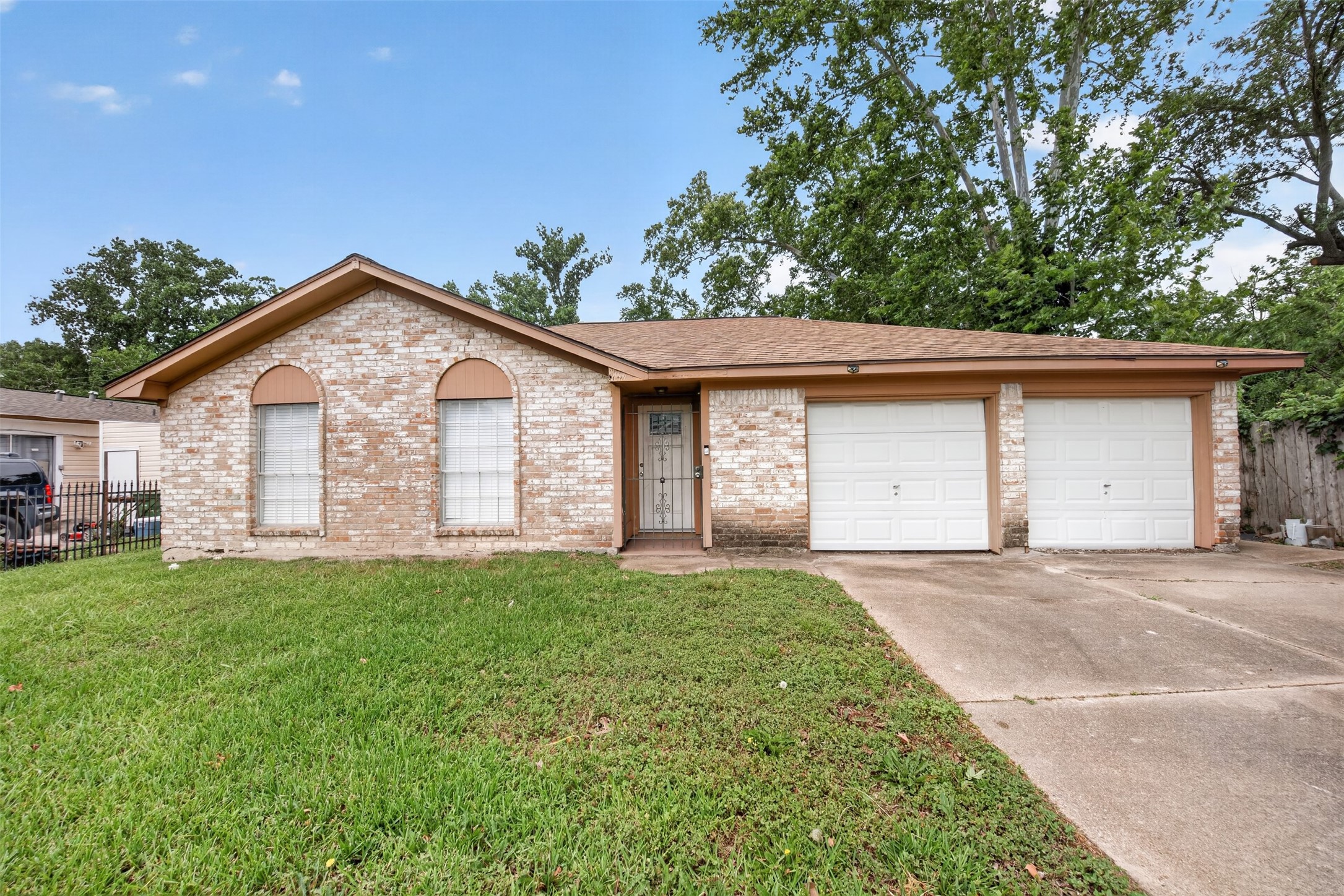 8029 Tareyton Lane Houston, TX 77075 - Photo 2 of 20 a front view of a house with a yard and garage