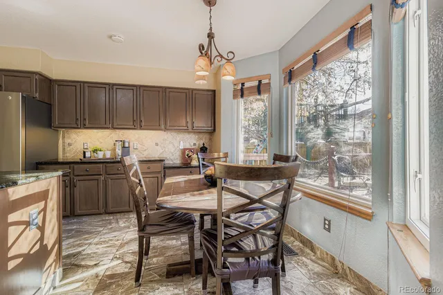 a kitchen with a table chairs stove and cabinets