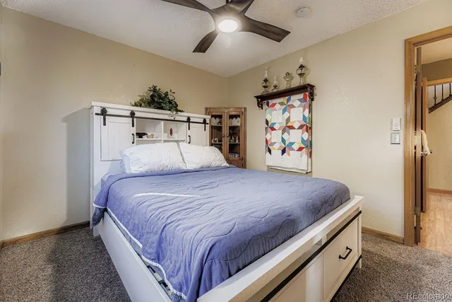 a bedroom with a large bed and a chandelier