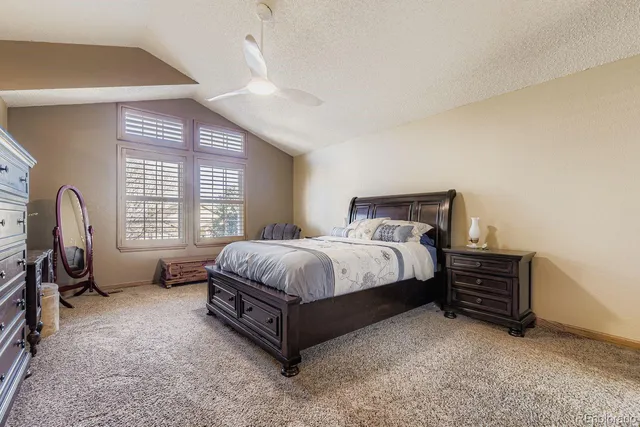 a spacious bedroom with a bed and a window