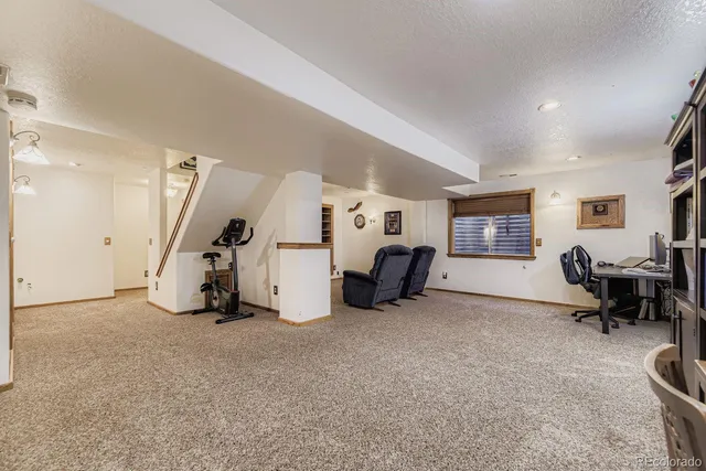 a view of a livingroom with entryway and furniture