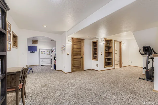 a view of a livingroom with furniture and staircase