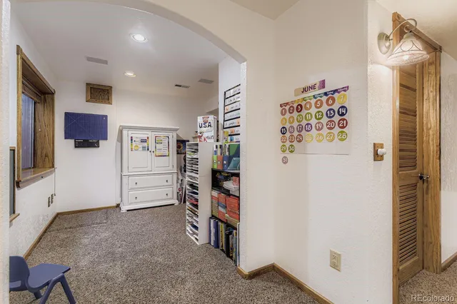 a view of a patio with table and chairs and potted plants with wooden floor and fence