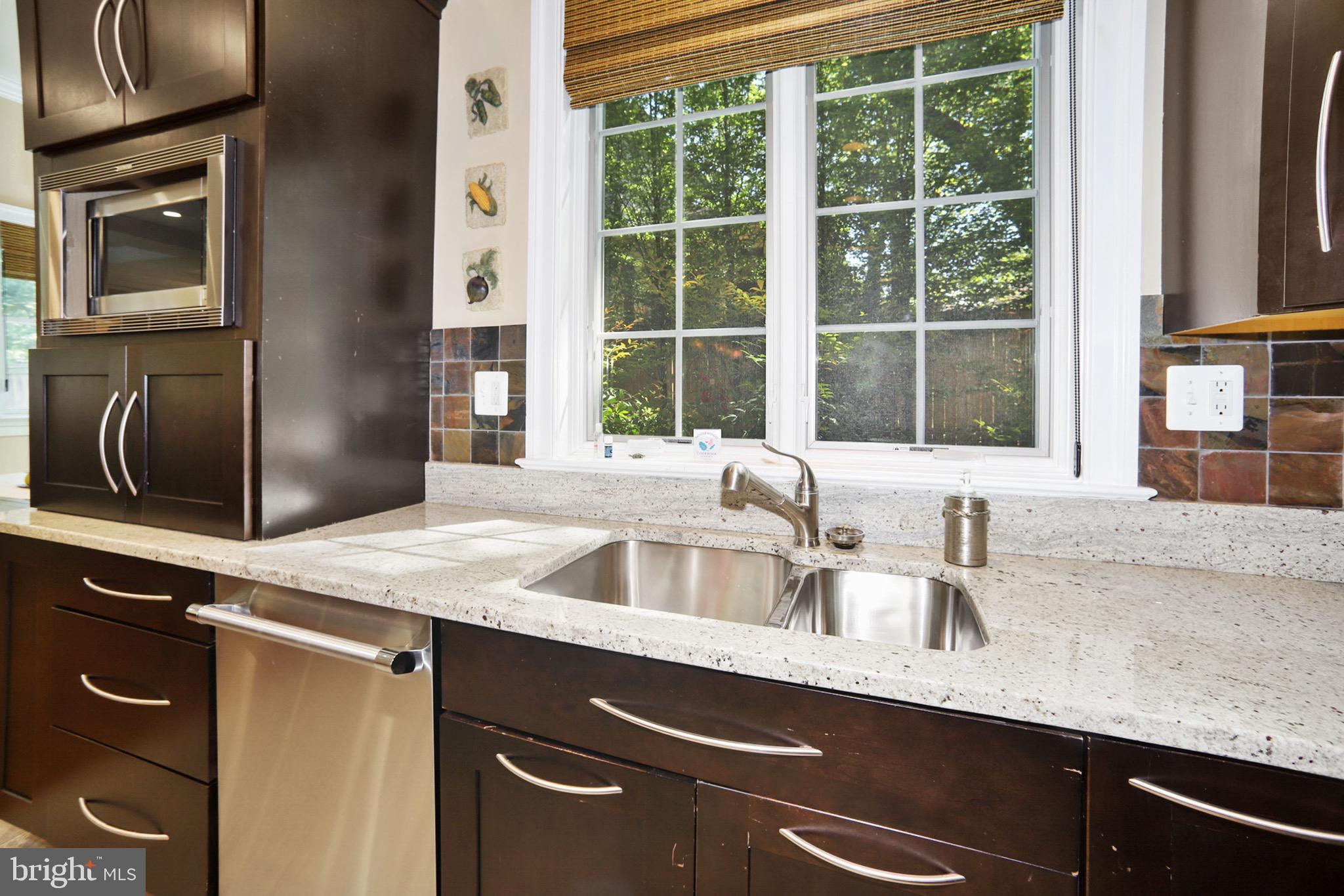 7117 Exfair Road Bethesda, MD 20814 - Photo 16 of 42 a kitchen with a sink and a window