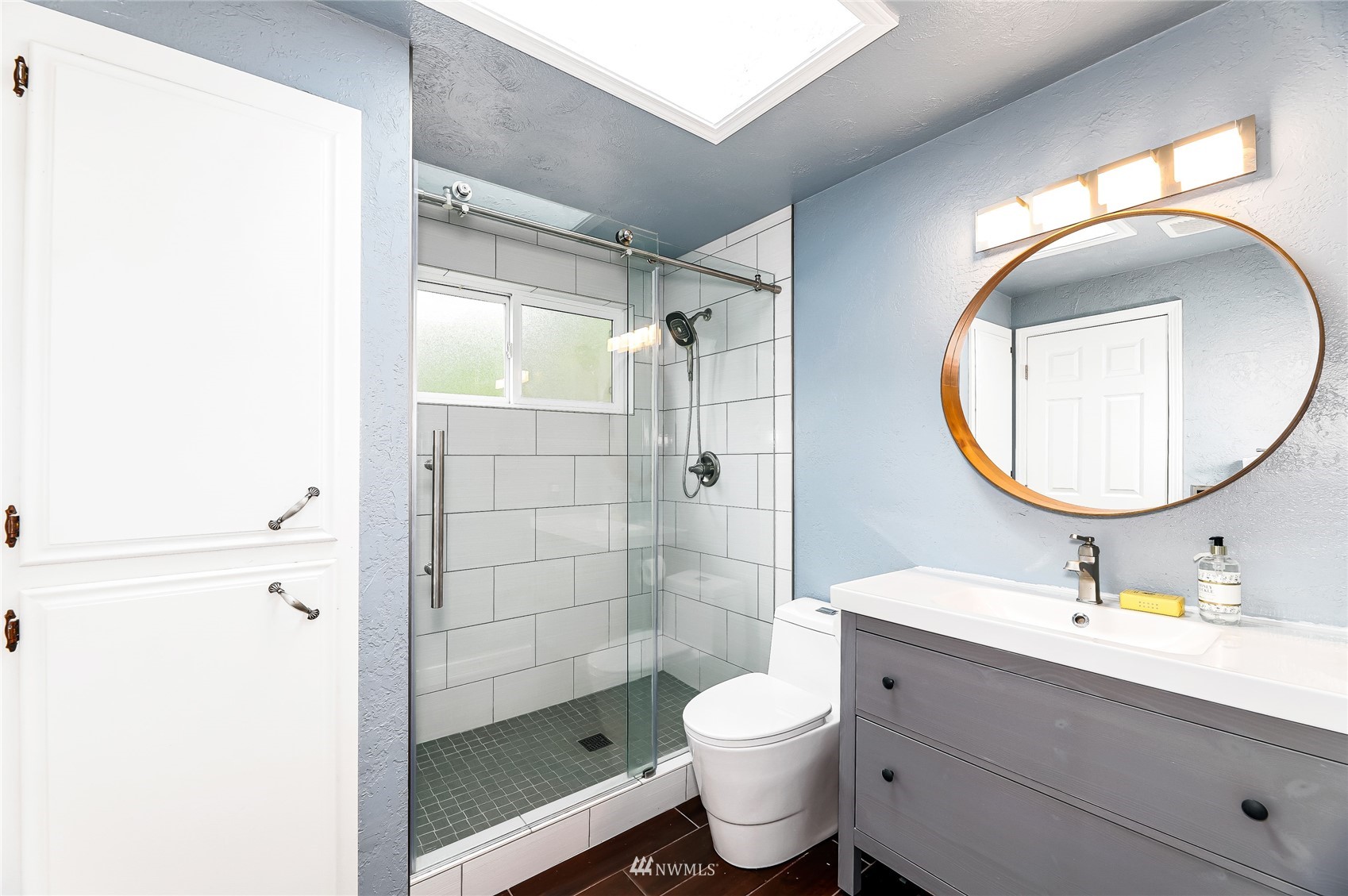 17818 Brook Boulevard Bothell, WA 98012 - Photo 13 of 27 a bathroom with a toilet a sink a mirror and shower