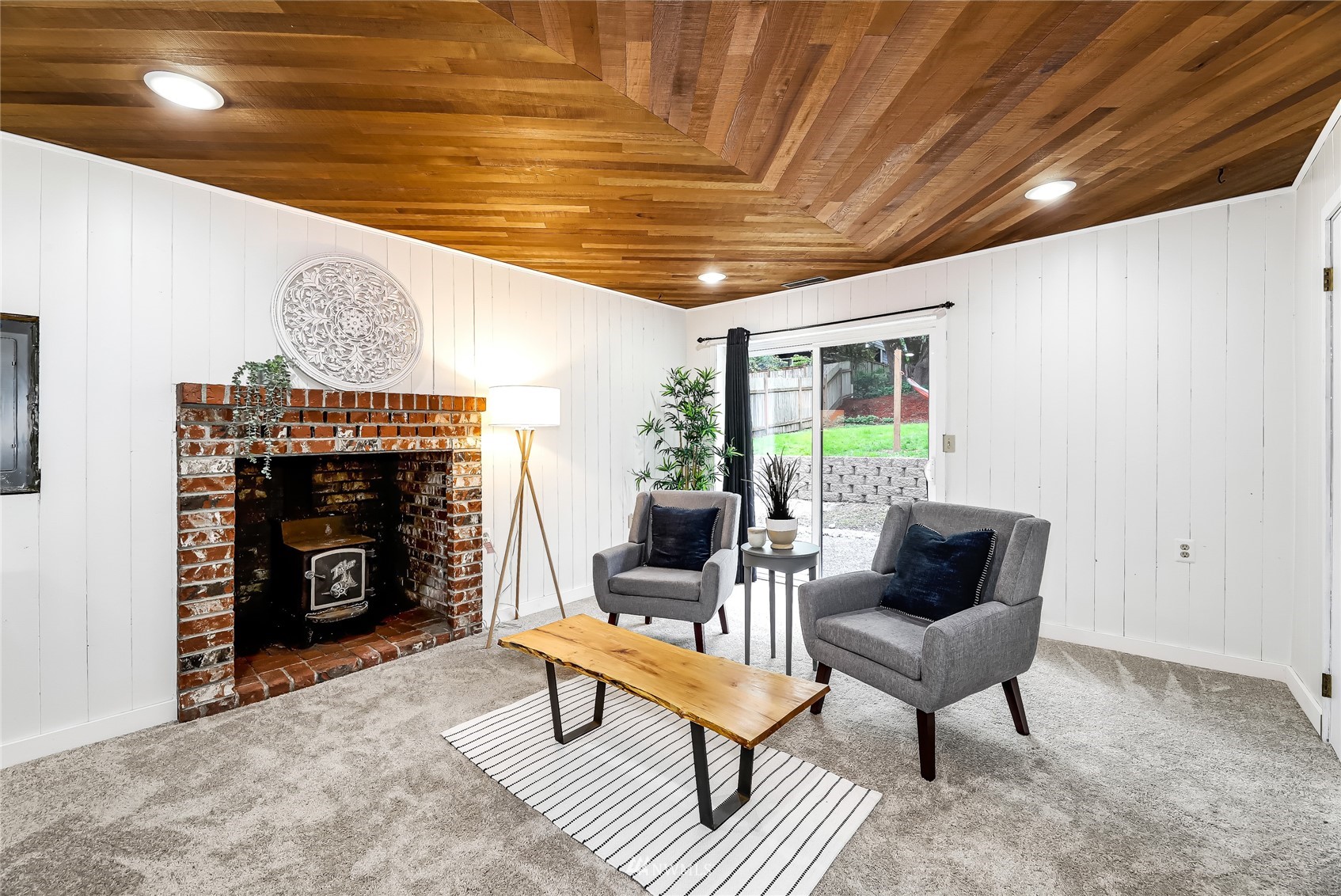 17818 Brook Boulevard Bothell, WA 98012 - Photo 16 of 27 a living room with furniture a fireplace and a table