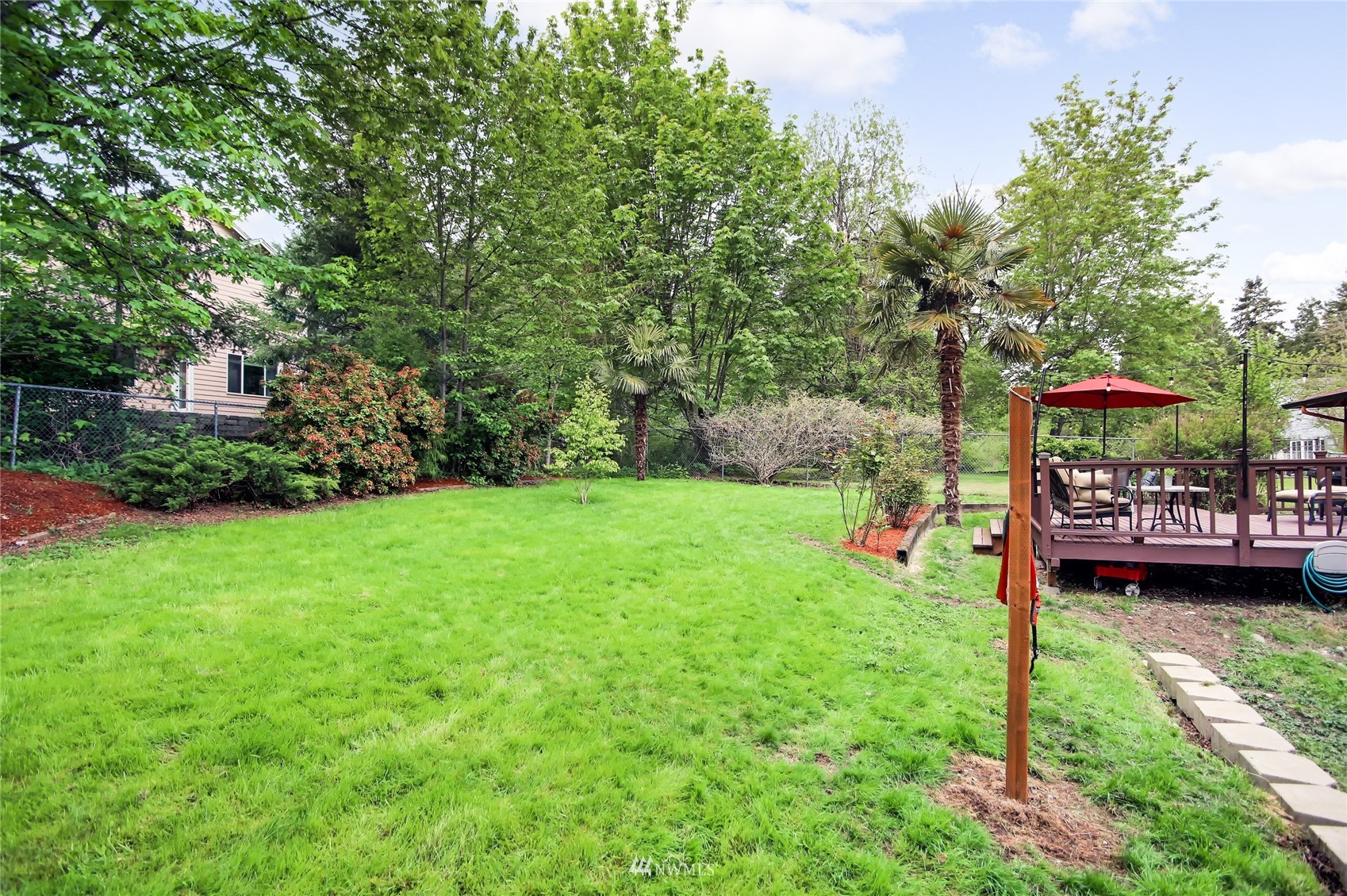 17818 Brook Boulevard Bothell, WA 98012 - Photo 23 of 27 a view of a backyard with a garden and trees