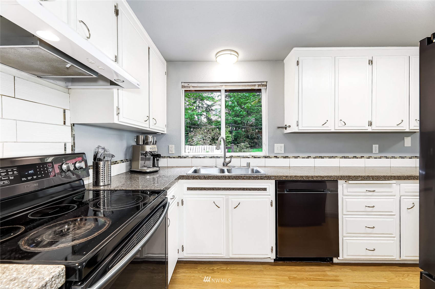 17818 Brook Boulevard Bothell, WA 98012 - Photo 10 of 27 a kitchen with a sink stove and cabinets
