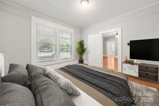 a bedroom with a bed and a flat screen television