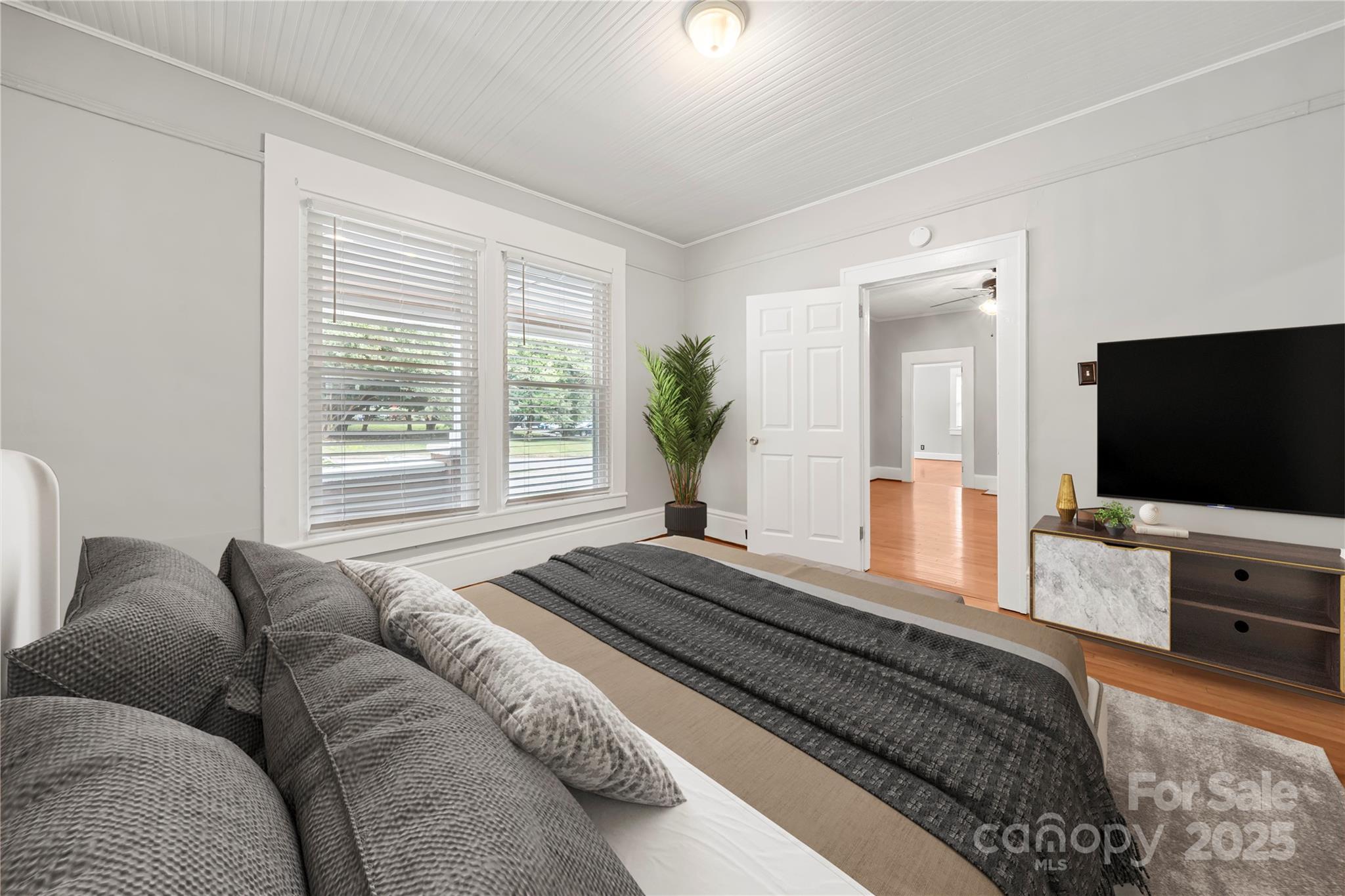 215 West D Street Newton, NC 28658 - Photo 12 of 48 a bedroom with a bed and a flat screen television