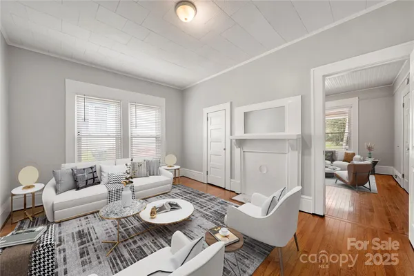 a living room with furniture and wooden floor