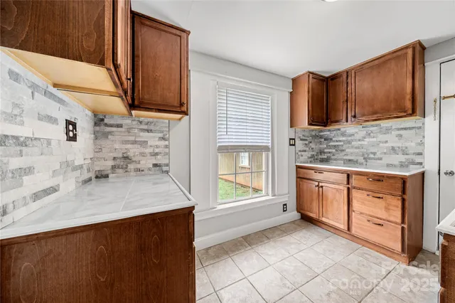 a kitchen with stainless steel appliances granite countertop a sink and a stove top oven