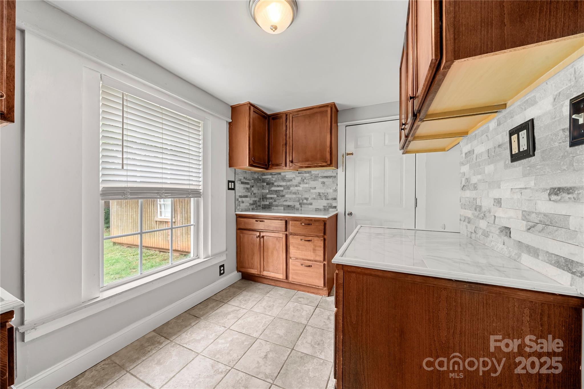 215 West D Street Newton, NC 28658 - Photo 21 of 48 a kitchen with stainless steel appliances granite countertop a stove a sink and a microwave