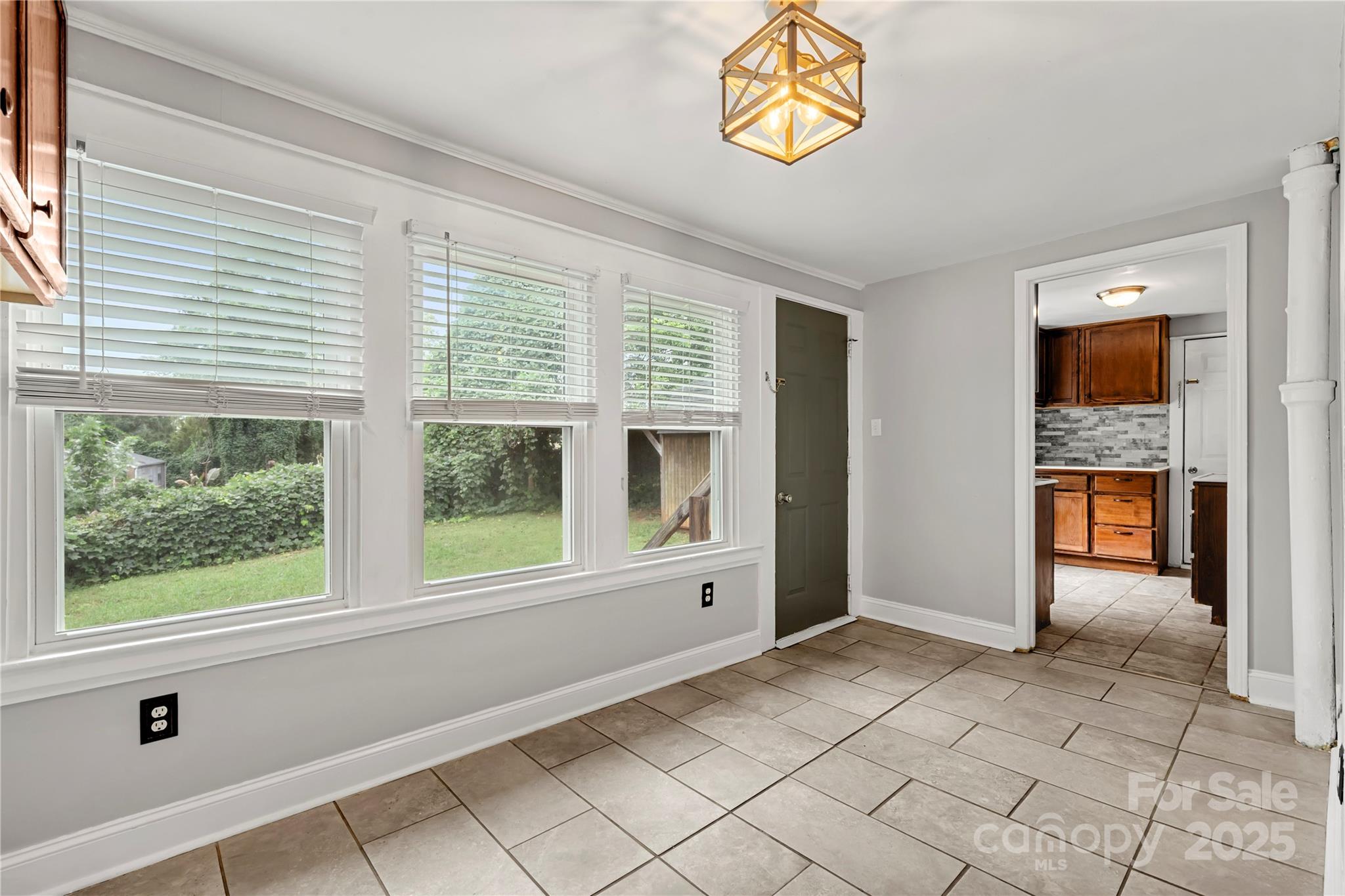 215 West D Street Newton, NC 28658 - Photo 25 of 48 wooden floor in an empty room with a window