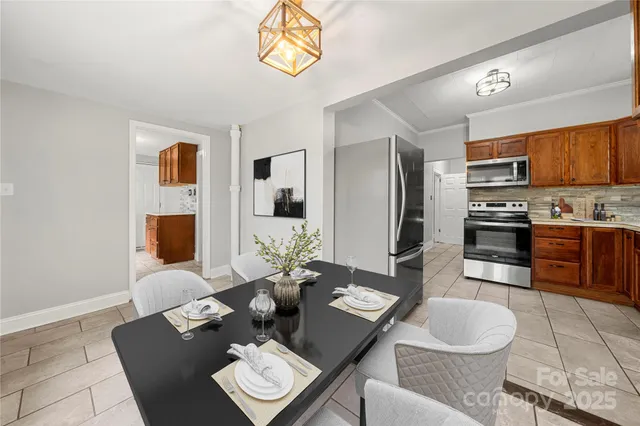 a dining room with furniture and a kitchen view