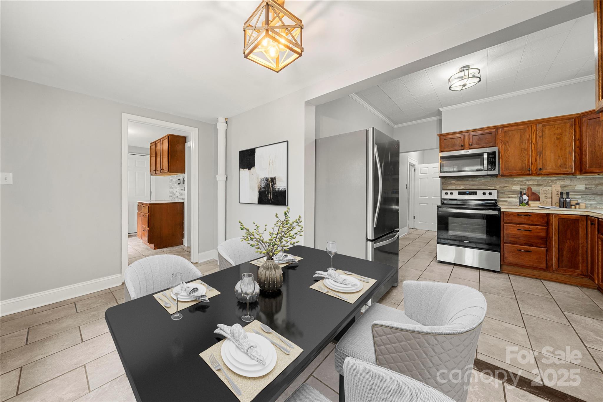 215 West D Street Newton, NC 28658 - Photo 26 of 48 a dining room with furniture and a kitchen view