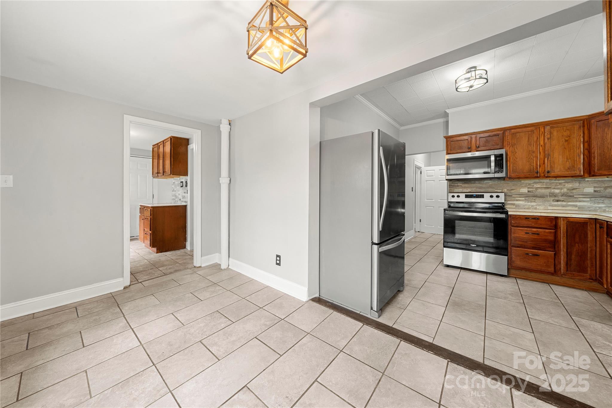 215 West D Street Newton, NC 28658 - Photo 27 of 48 a kitchen with stainless steel appliances granite countertop a refrigerator and a stove top oven
