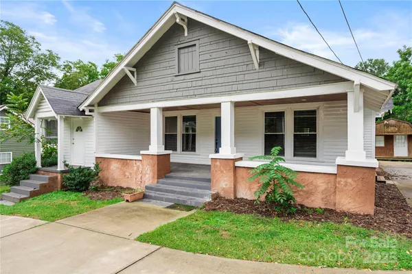 a front view of a house with garden and porch