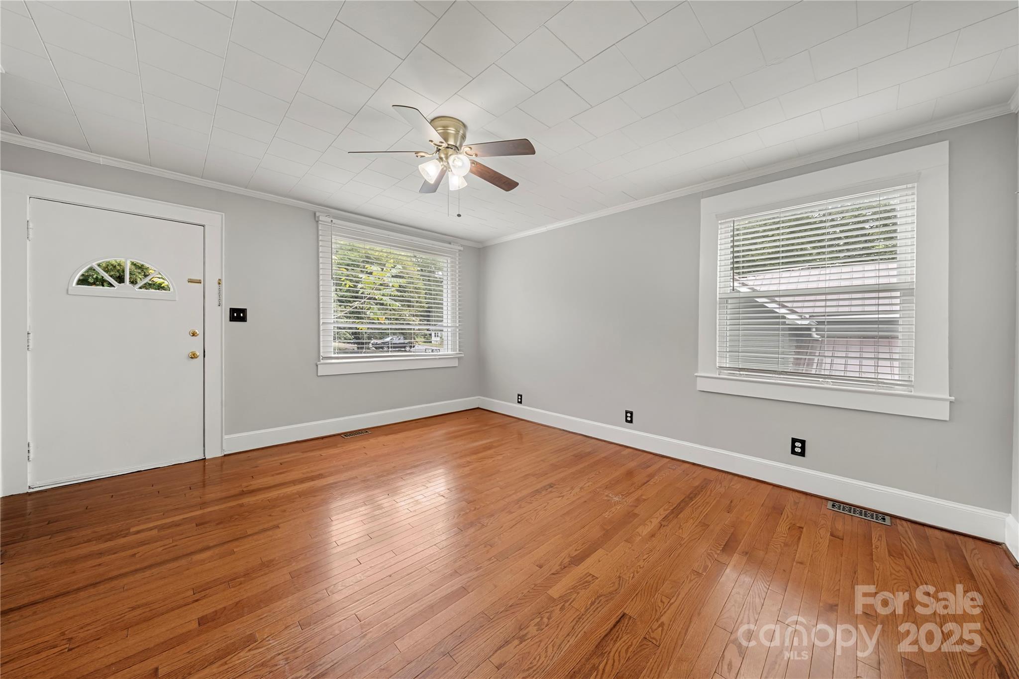 215 West D Street Newton, NC 28658 - Photo 35 of 48 a view of empty room with wooden floor and fan