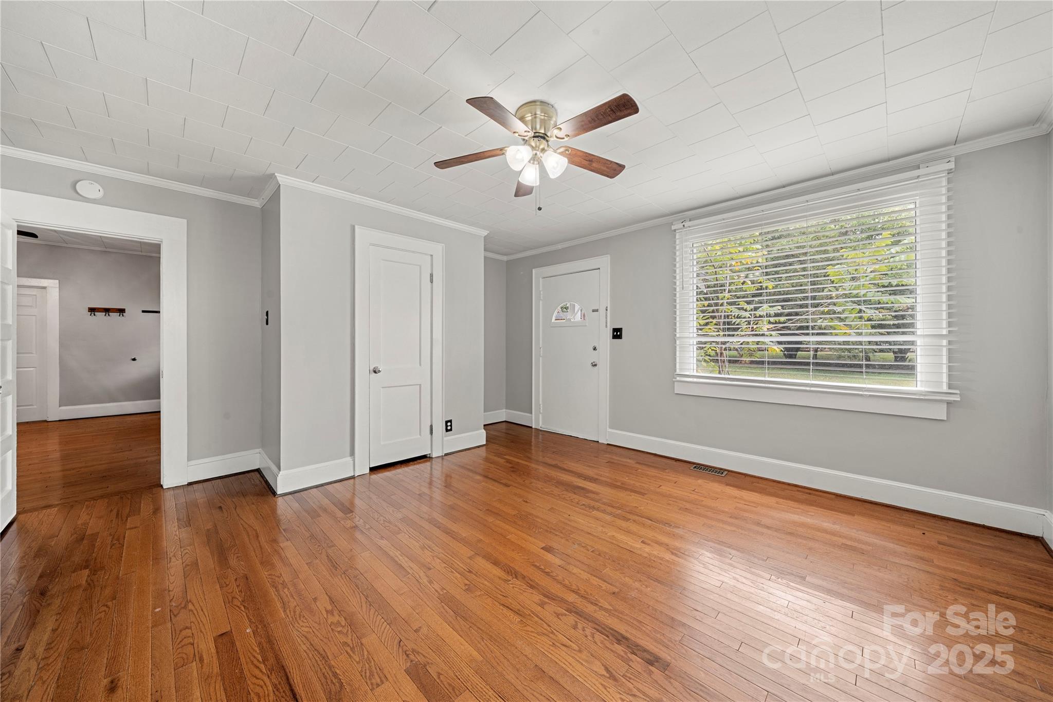 215 West D Street Newton, NC 28658 - Photo 37 of 48 a view of an empty room with wooden floor and a window