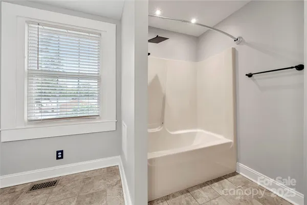 a bathroom with a bathtub and a shower