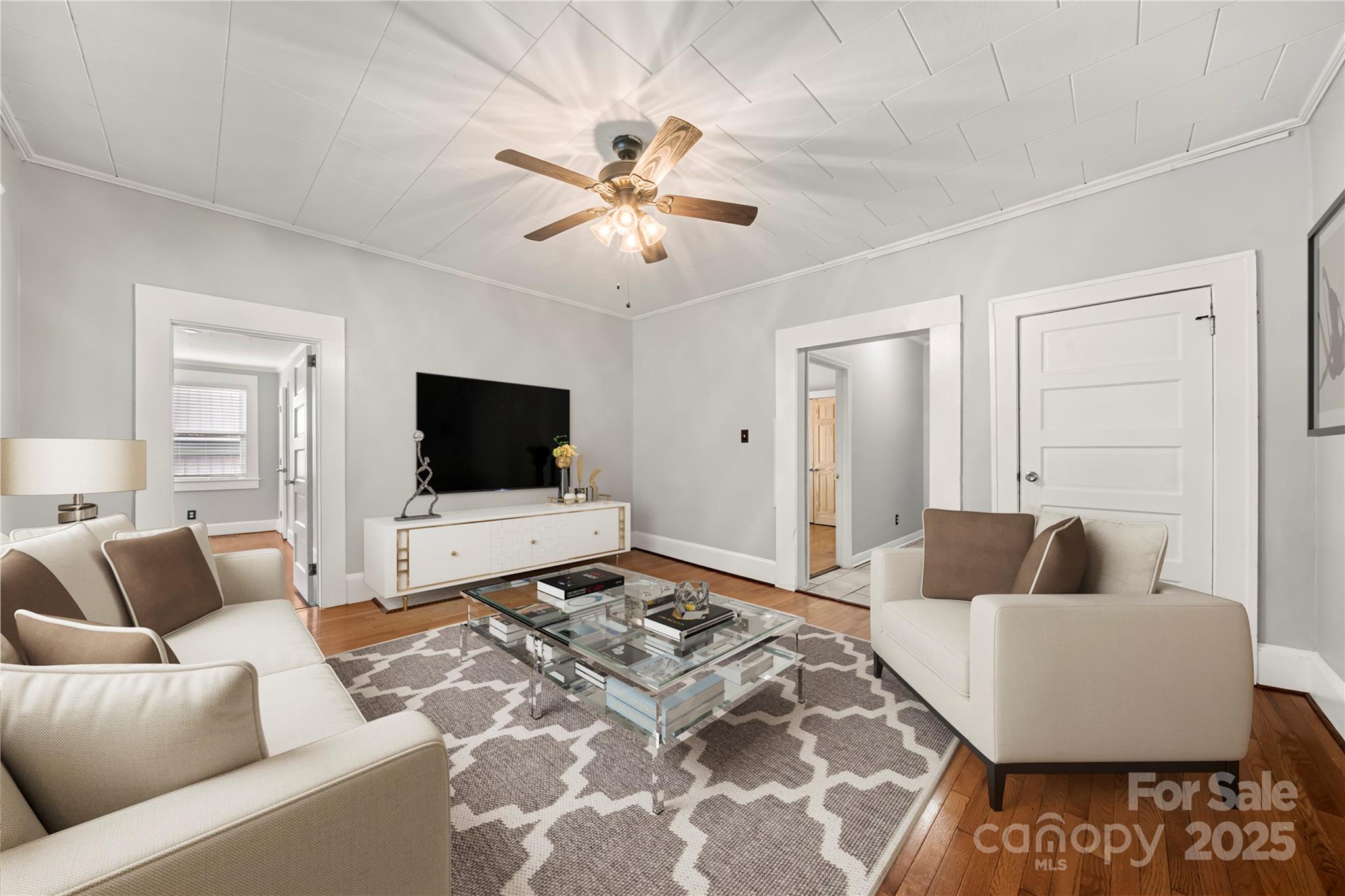 215 West D Street Newton, NC 28658 - Photo 9 of 48 a living room with furniture and a flat screen tv