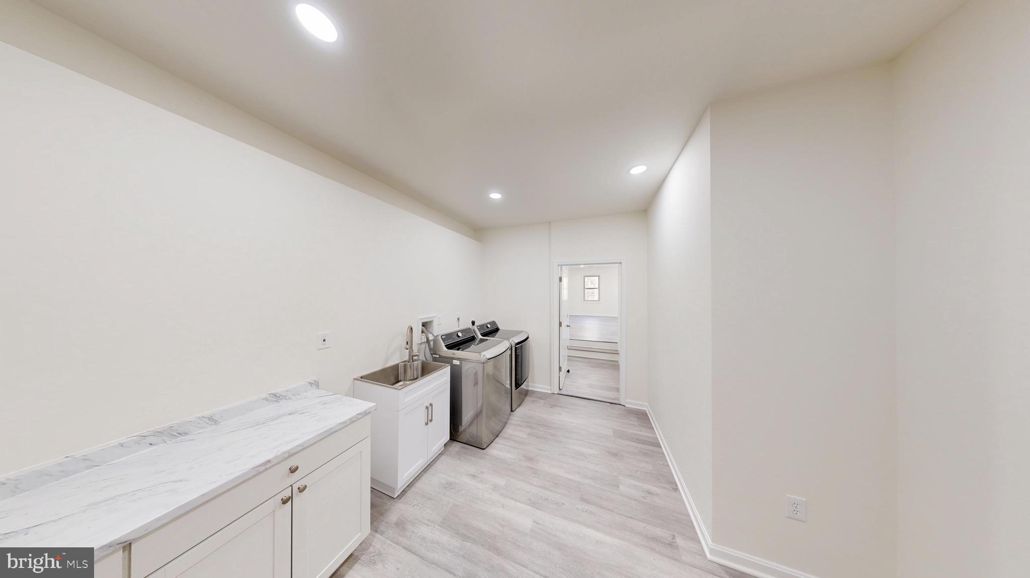 729 West Watersville Road Mount Airy, MD 21771 - Photo 7 of 42 a hallway with washer and dryer