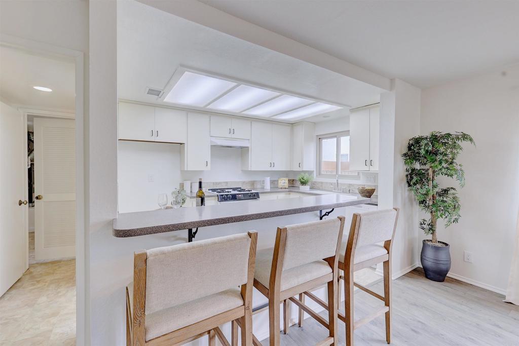 418 3rd Street Encinitas, CA 92024 - Photo 20 of 74 a kitchen with granite countertop a table and chairs in it