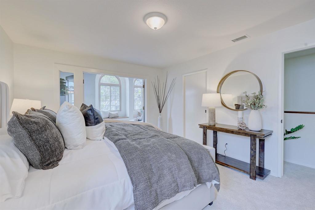 418 3rd Street Encinitas, CA 92024 - Photo 28 of 74 a bedroom with bed a mirror and a window