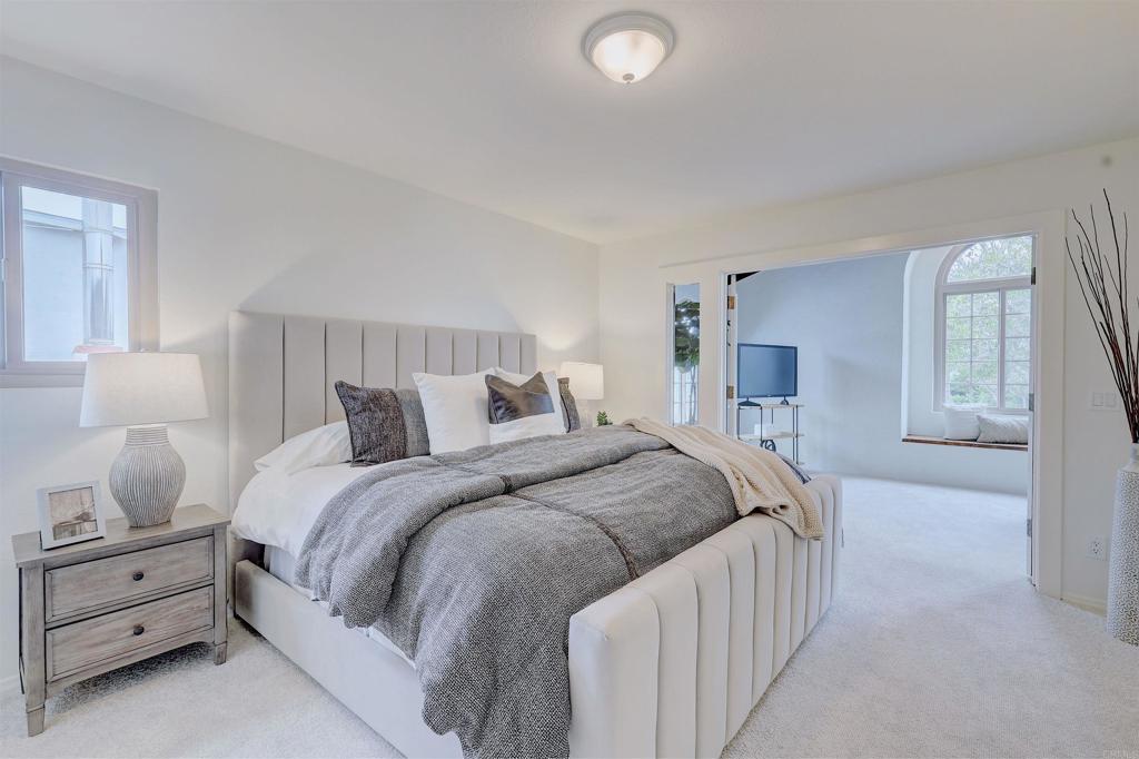 418 3rd Street Encinitas, CA 92024 - Photo 29 of 74 a spacious bedroom with a bed and a lamp