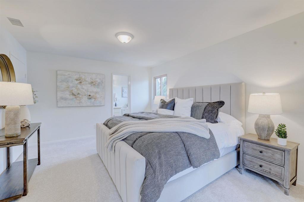 418 3rd Street Encinitas, CA 92024 - Photo 33 of 74 a spacious bedroom with a bed and a lamp on dresser