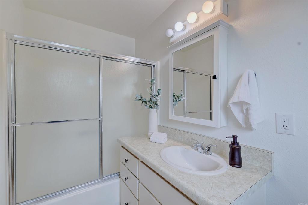 418 3rd Street Encinitas, CA 92024 - Photo 35 of 74 a bathroom with a sink and a mirror