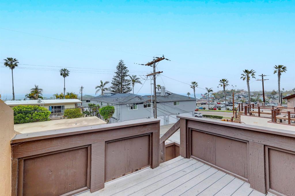 418 3rd Street Encinitas, CA 92024 - Photo 49 of 74 a kitchen with kitchen island granite countertop a sink and dishwasher wooden cabinets with potted plant
