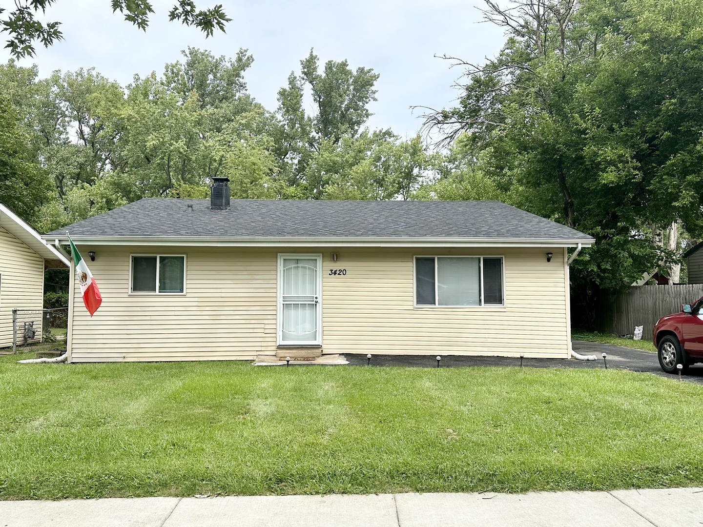 3420 Roesner Drive Markham, IL 60428 - Photo 1 of 21 a front view of a house with a garden and yard
