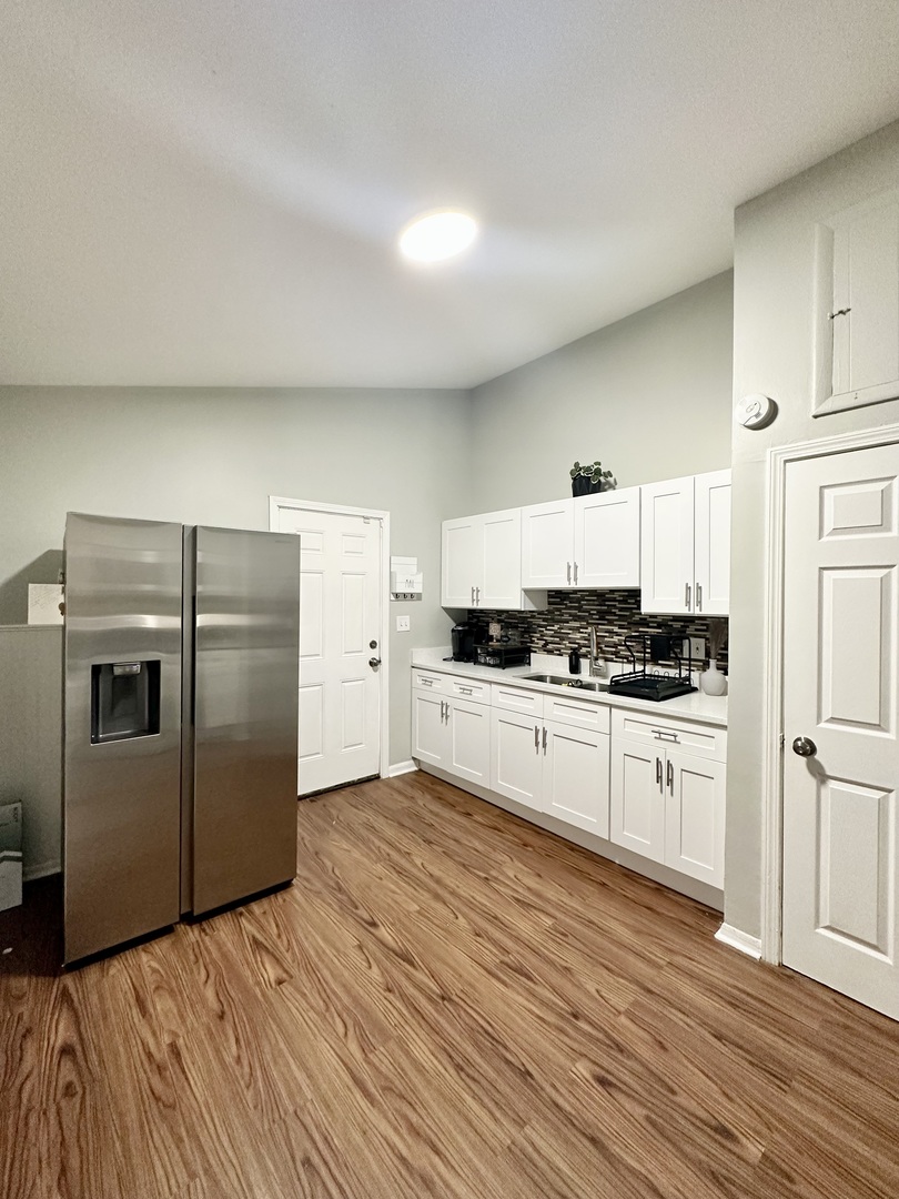 3420 Roesner Drive Markham, IL 60428 - Photo 4 of 21 a kitchen with a refrigerator and white cabinets