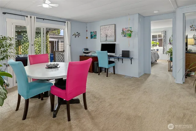 a view of a livingroom with furniture and a dining table