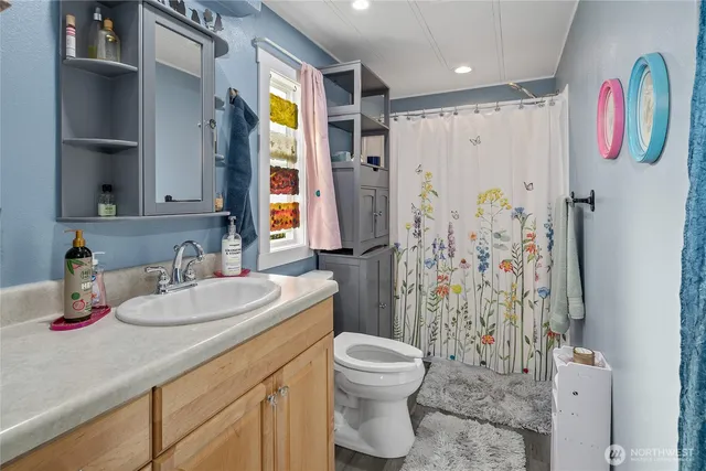 a bathroom with a sink toilet and shower