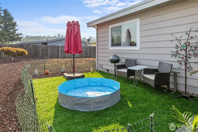 a view of a backyard with table and chairs