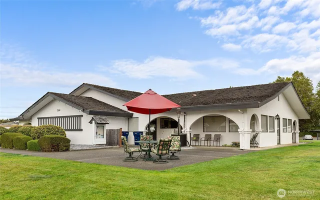 a front view of a house with swimming pool and porch