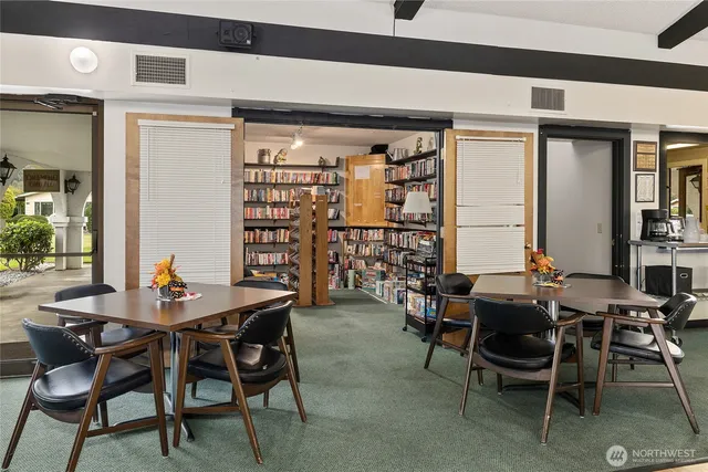 a dining room with furniture and a window