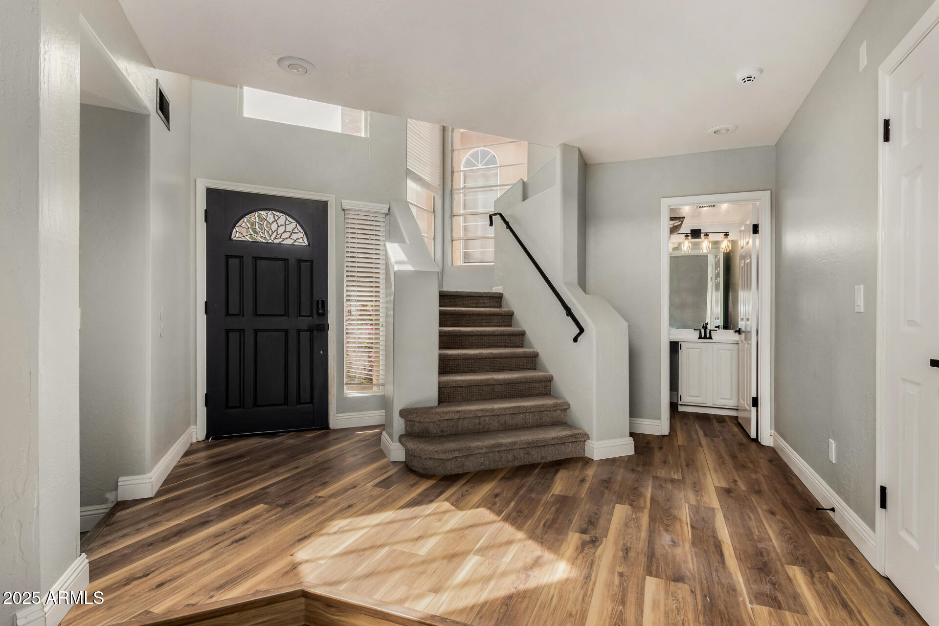 3832 North Gallatin Mesa, AZ 85215 - Photo 15 of 41 a view of a hallway with wooden floor and staircase