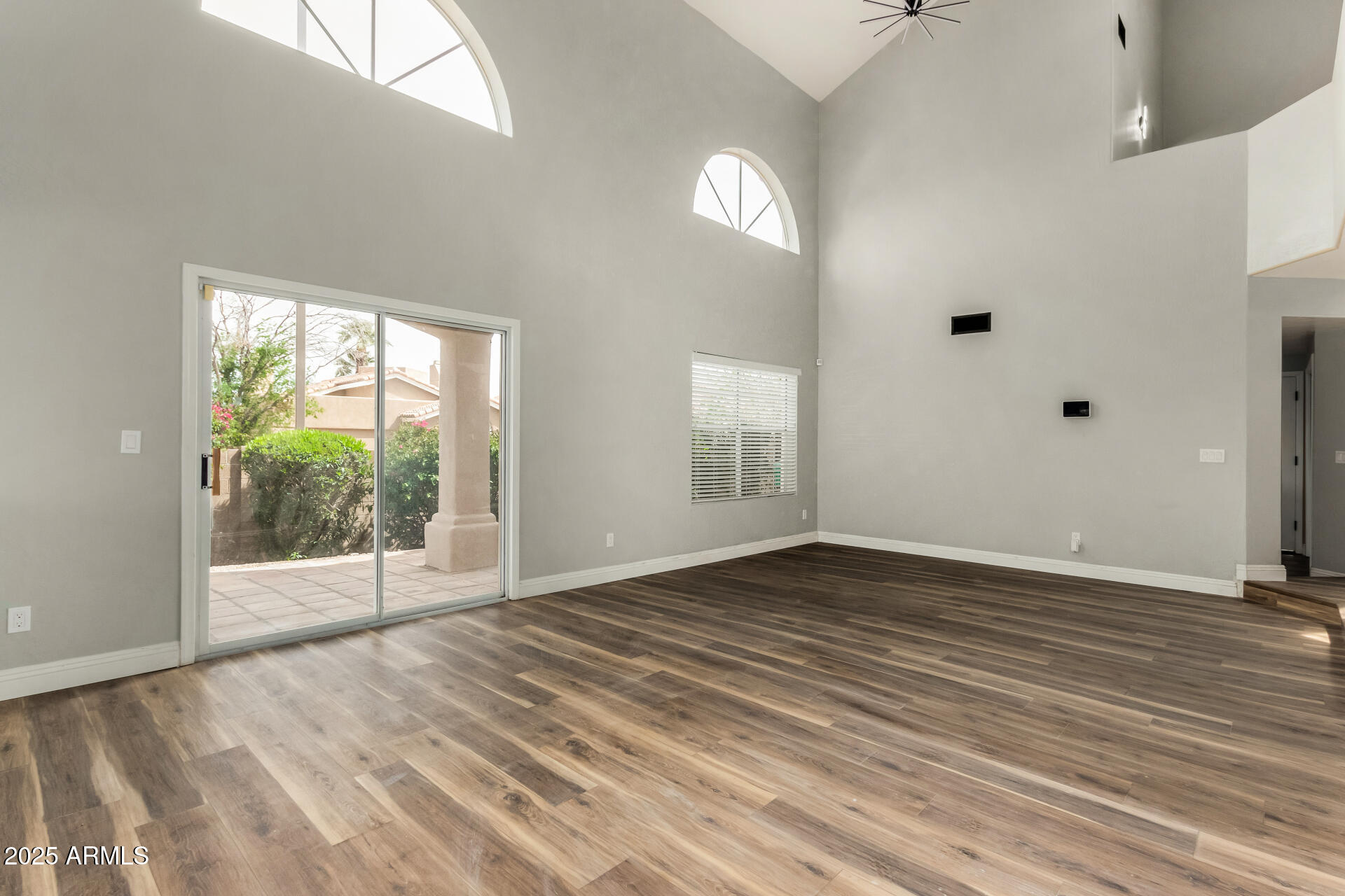 3832 North Gallatin Mesa, AZ 85215 - Photo 16 of 41 a view of an empty room with wooden floor and a window