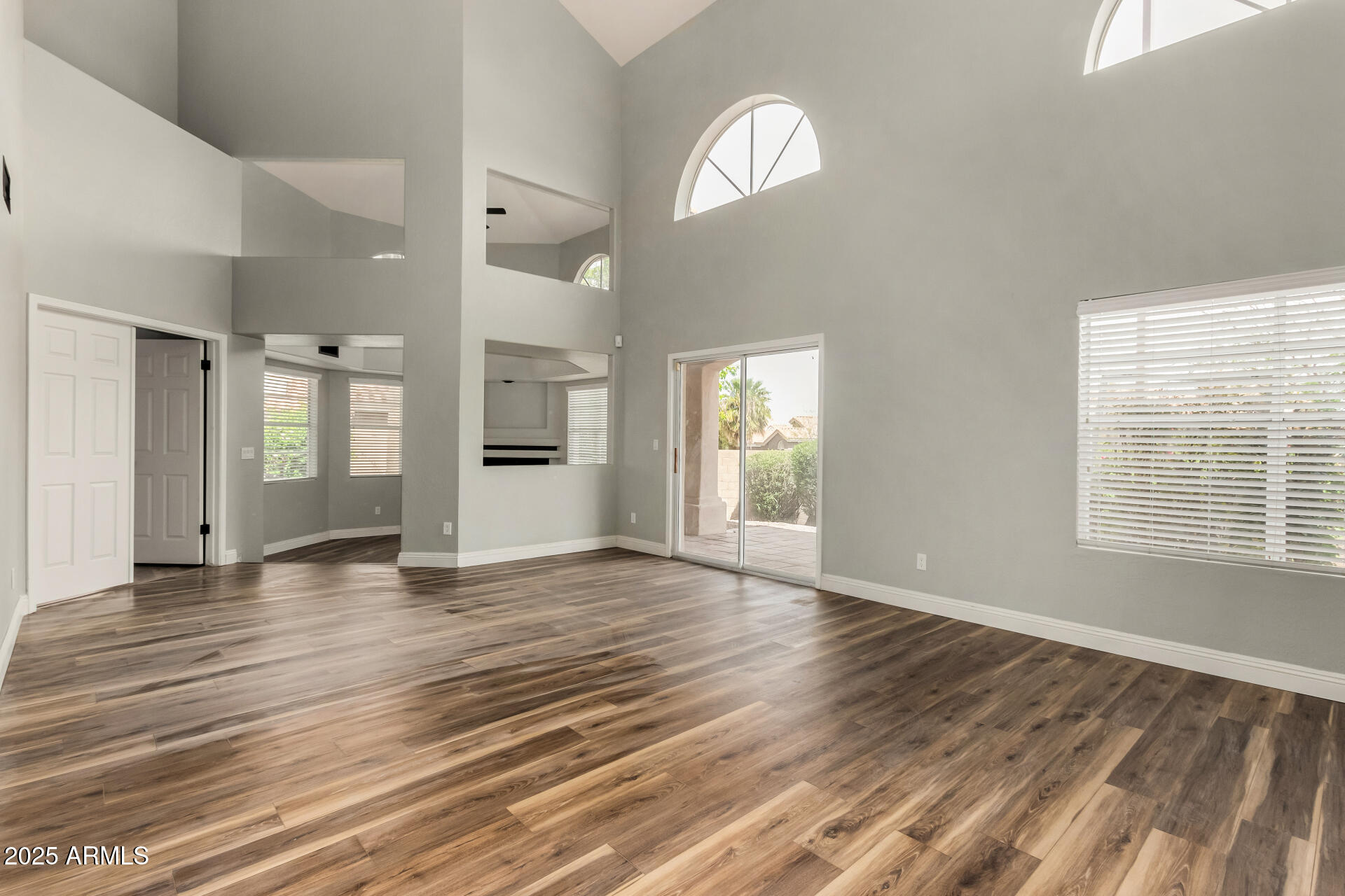 3832 North Gallatin Mesa, AZ 85215 - Photo 18 of 41 an empty room with wooden floor and windows