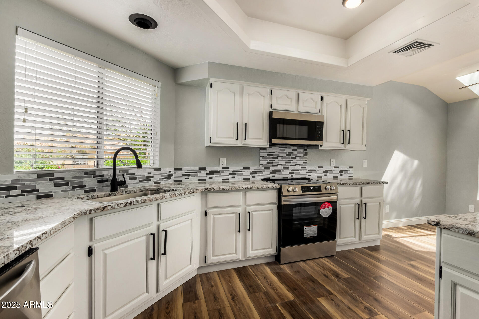 3832 North Gallatin Mesa, AZ 85215 - Photo 2 of 41 a kitchen with stainless steel appliances granite countertop a stove sink and cabinets