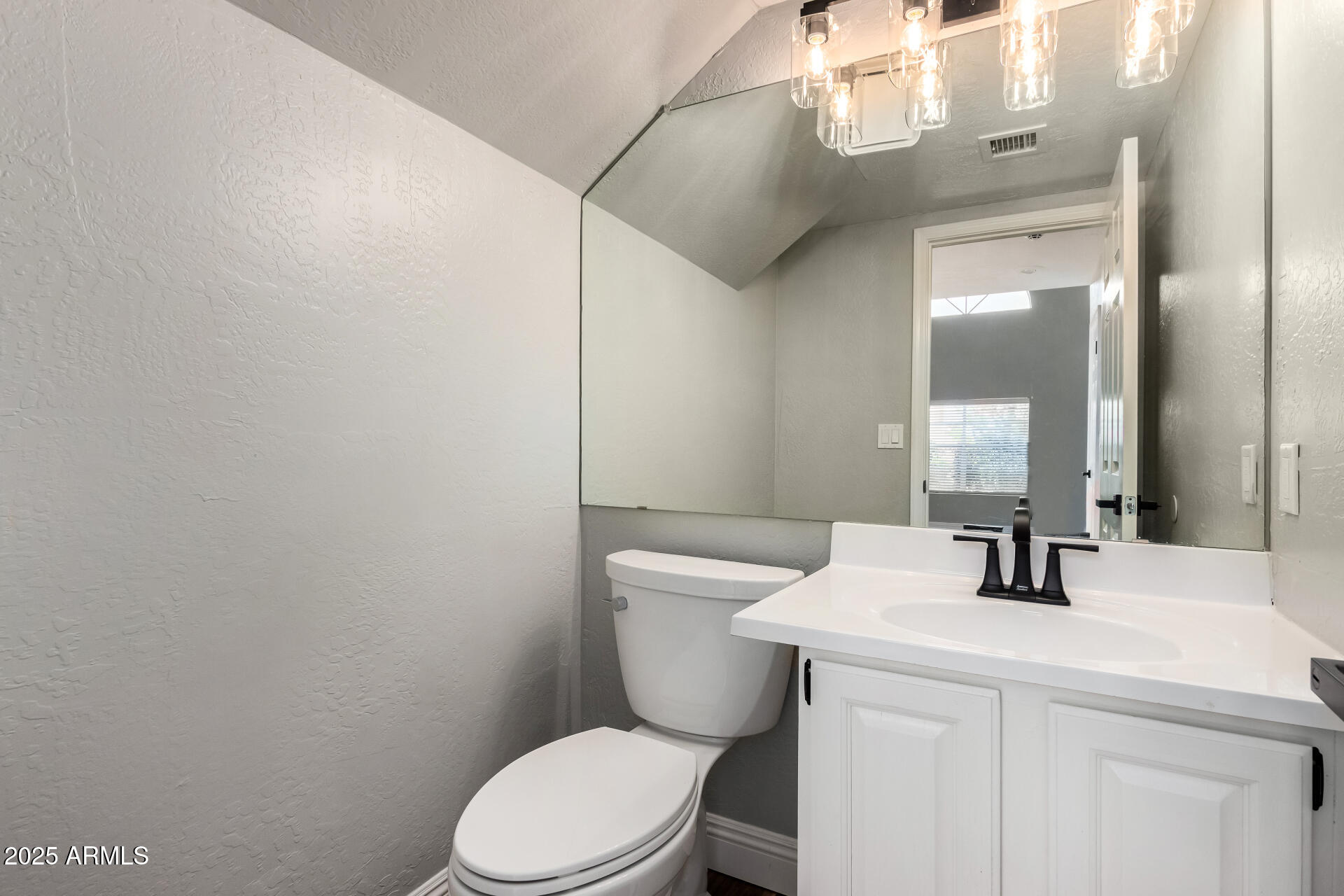 3832 North Gallatin Mesa, AZ 85215 - Photo 22 of 41 a bathroom with a sink a toilet a mirror and shower curtain